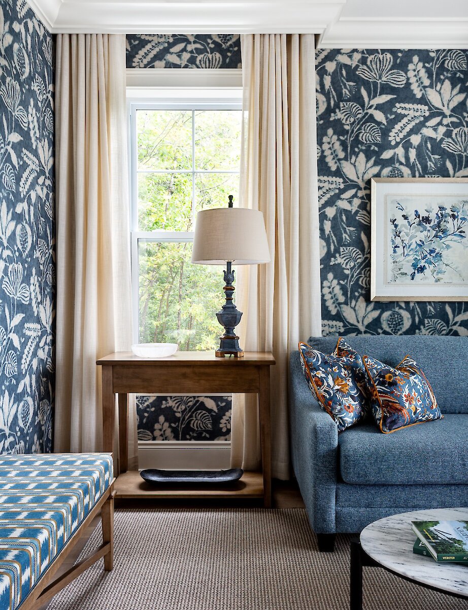 A room with wallpaper and a view of the forest