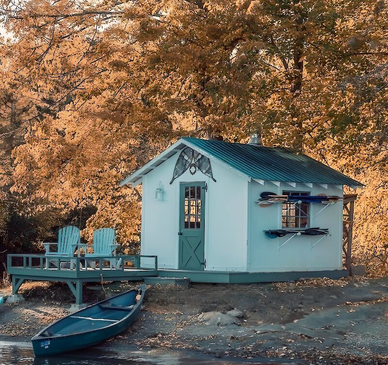 A little house by the lake with a canoe on the beach